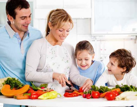 Happy family preparing a healthy dinner at home.