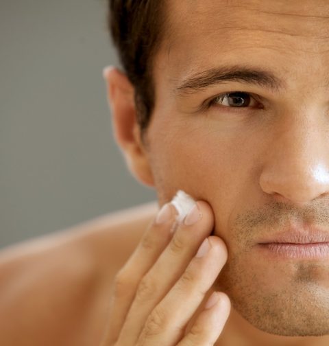 Close-up of young man applying shaving cream