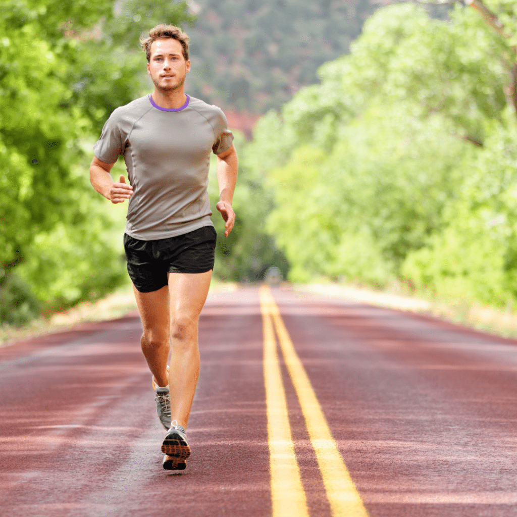Muškarac trči cestom tijekom završne faze ACL rehabilitacije, fokus na povratak sprintu i punoj funkcionalnosti koljena nakon operacije prednjeg križnog ligamenta.